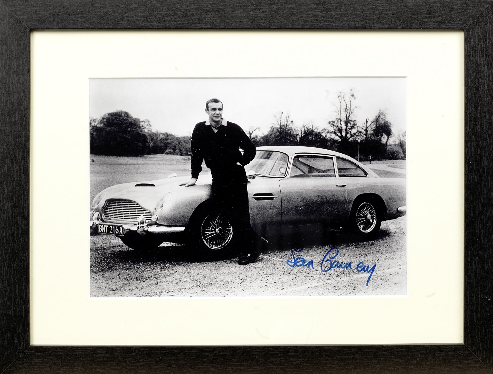 Two framed 'Goldfinger' images with signatures, one featuring the Aston Martin DB5, ((2))