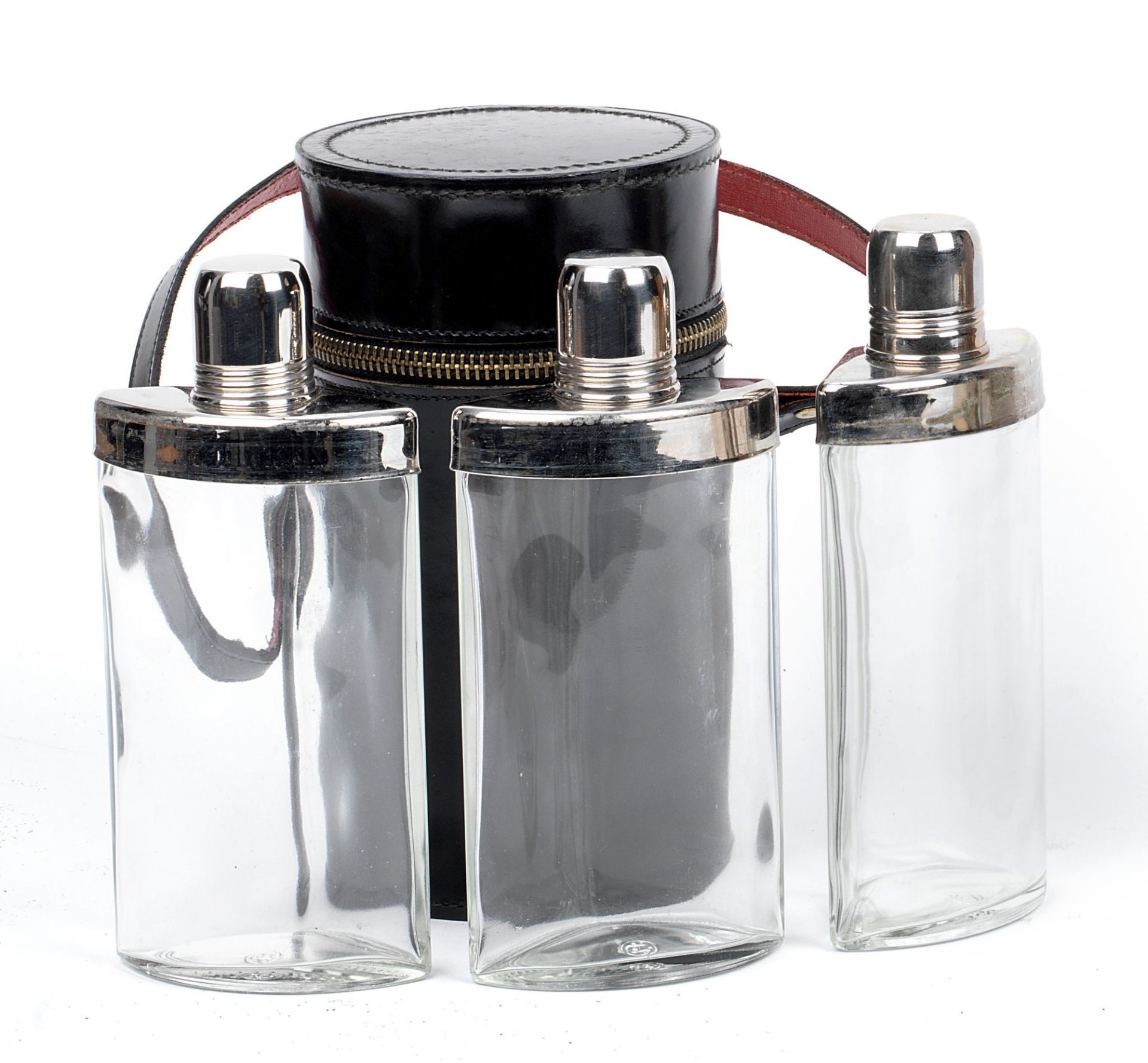 A leather-cased travelling set of three sprits flasks,