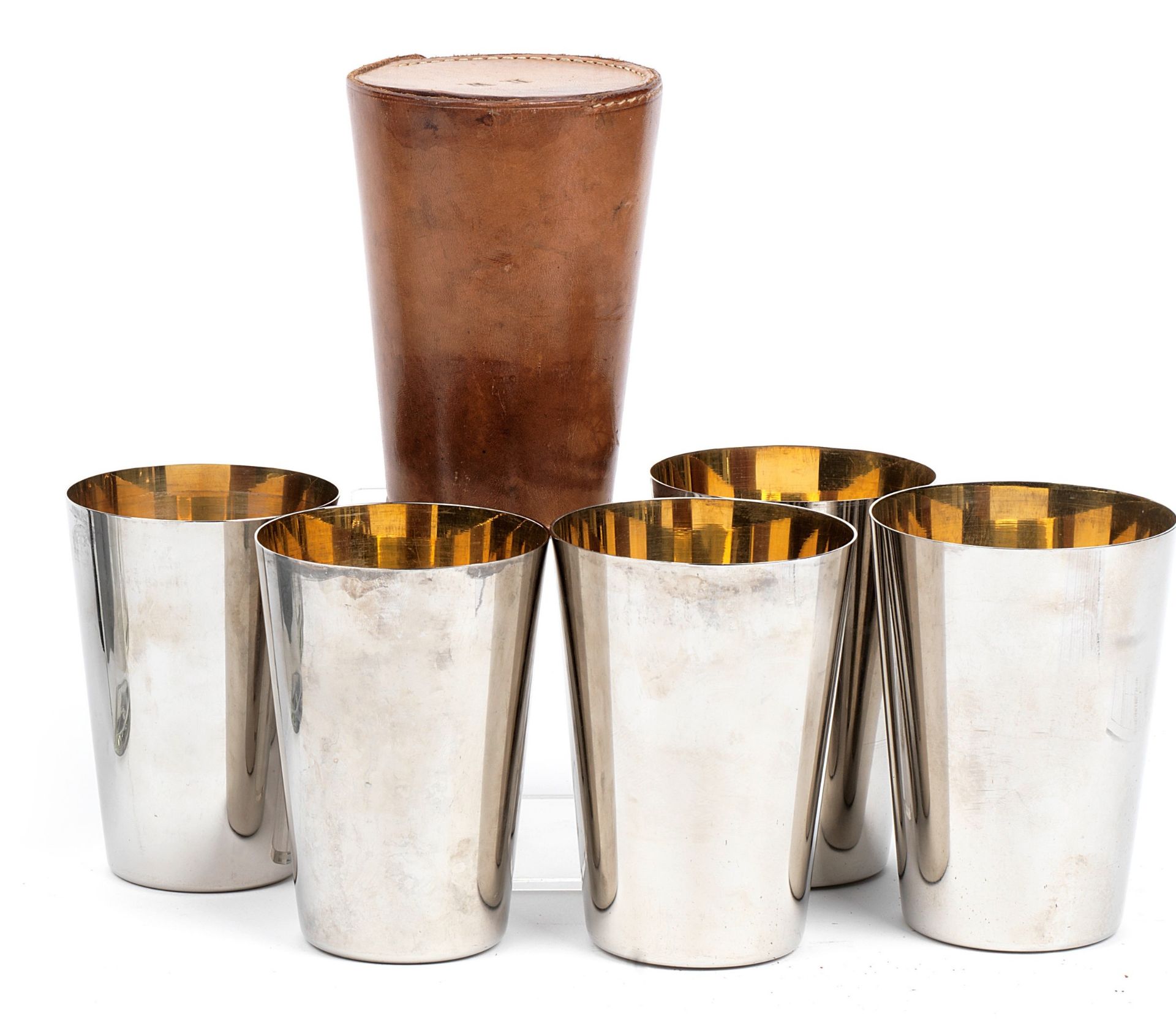 A vintage leather-cased set of five graduated beakers,