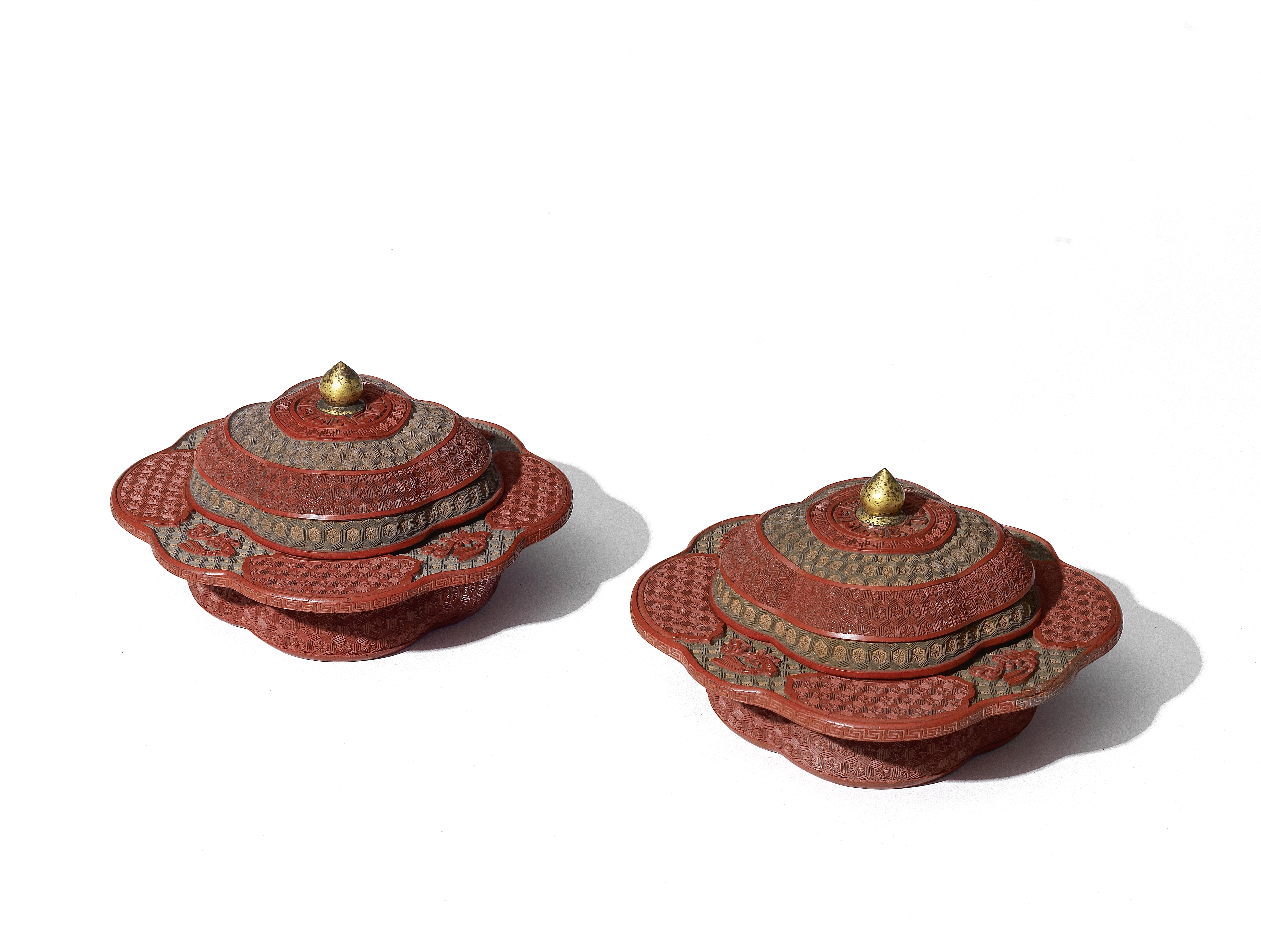 A FINE AND RARE PAIR OF THREE-COLOUR CINNABAR LACQUER CARVED PRUNUS-SHAPED BOWLS AND COVERS, ZHAD...