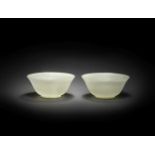 A PAIR OF PALE GREEN JADE BOWLS 18th century (4)
