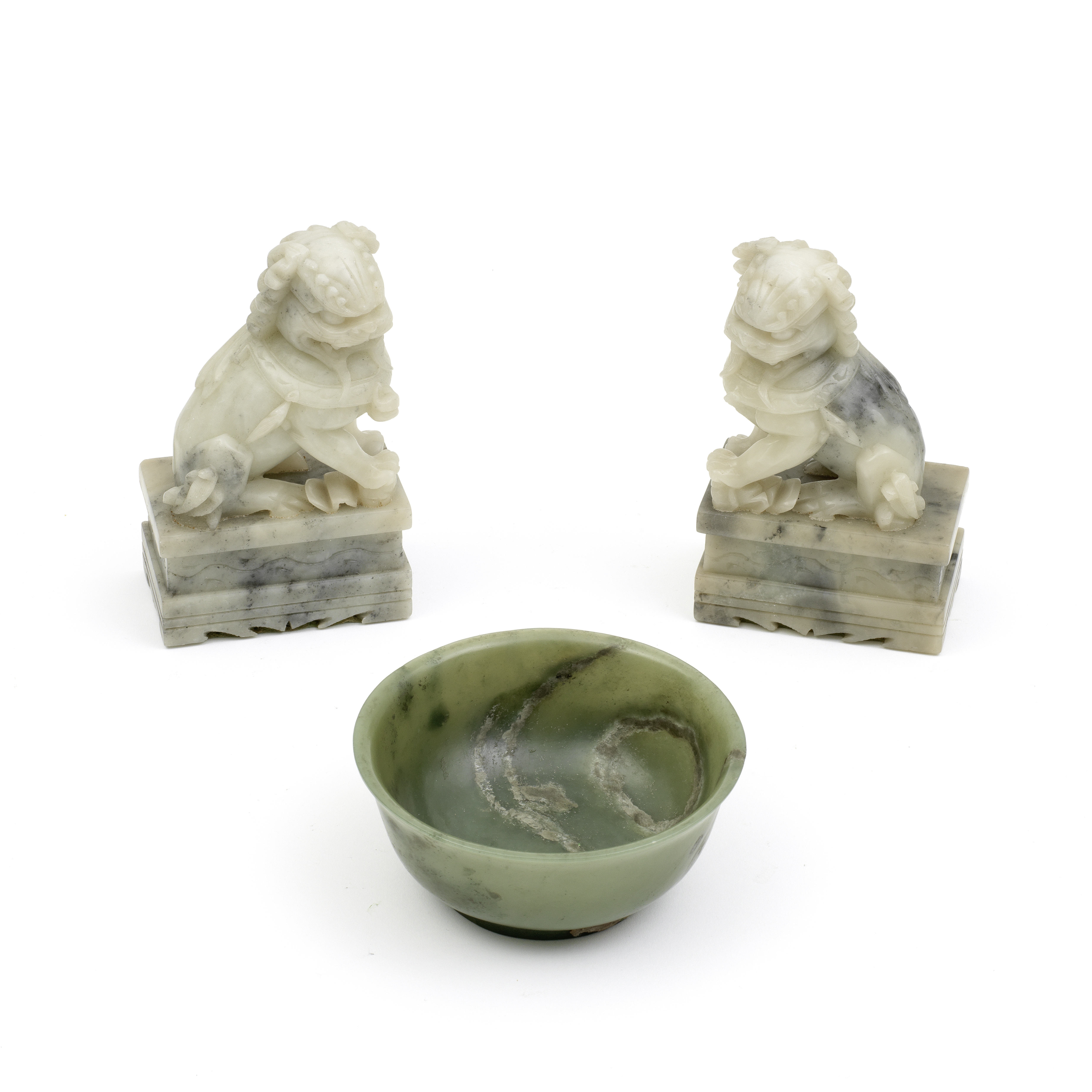 A SPINACH GREEN JADE BOWL AND A PAIR OF 'BUDDHIST LION' CARVINGS Late Qing Dynasty (4)