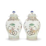 A MIRRORED PAIR OF FAMILLE ROSE 'LADIES AND DEER' JARS AND COVERS 18th/19th century (4)