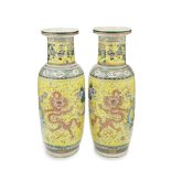 A LARGE PAIR OF FAMILLE ROSE YELLOW-GROUND 'FIVE DRAGON' ROULEAU VASES 19th century (2)