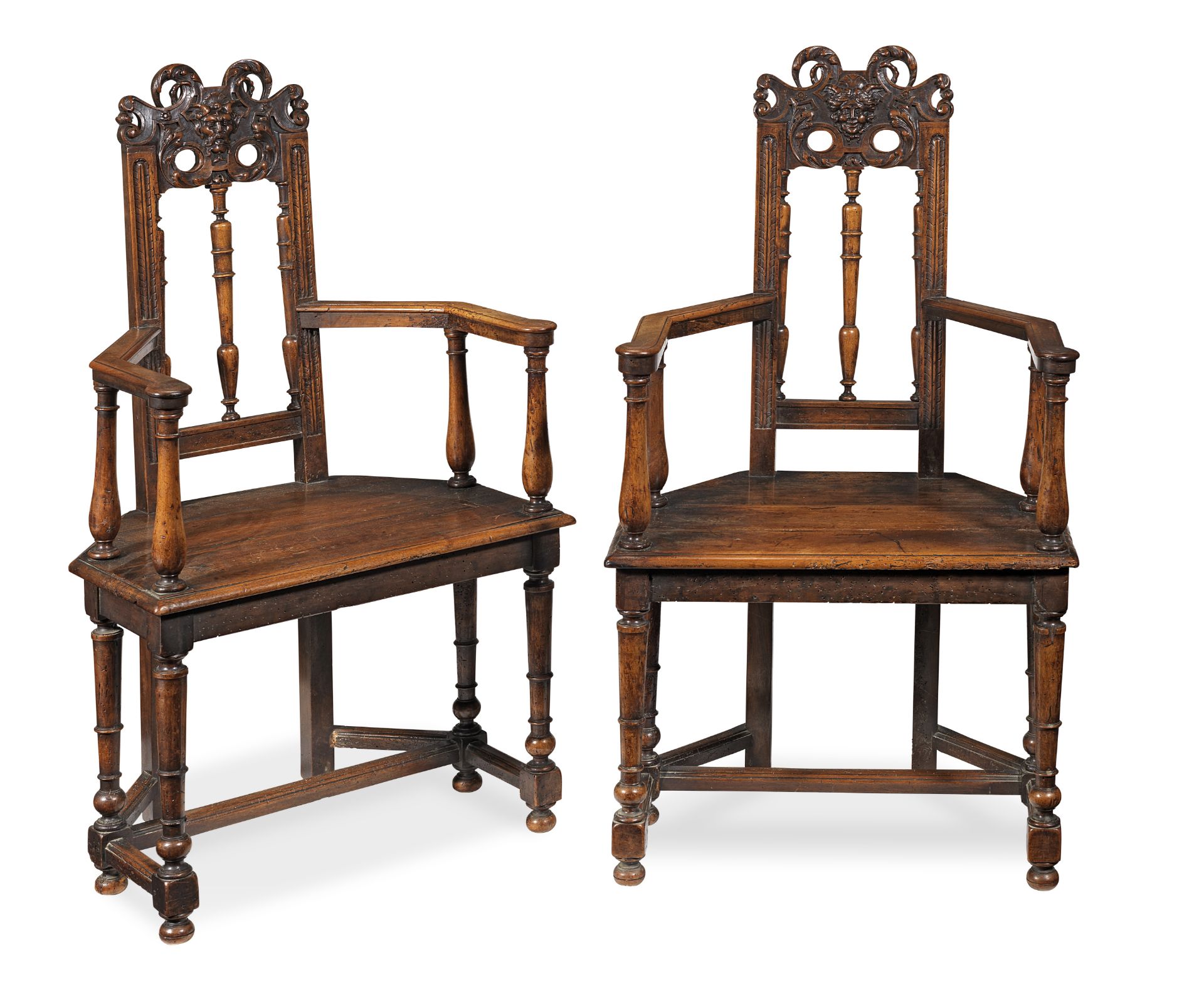 A pair of French carved walnut caqueteuses or open armchairs late 16th/early 17th century with so...