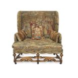 An early 20th century walnut settee or sofa of narrow proportions in the Queen Anne style