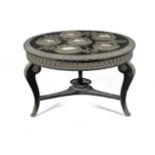 A French early 20th century ebony and ebonised low table inset with four contemporary enamels and...