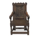 A Commonwealth period carved oak 'wainscot' armchair The Lake District, dated: 1658