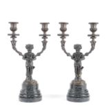 A pair of late 19th century French patinated and gilt bronze twin light figural candelabra the f...