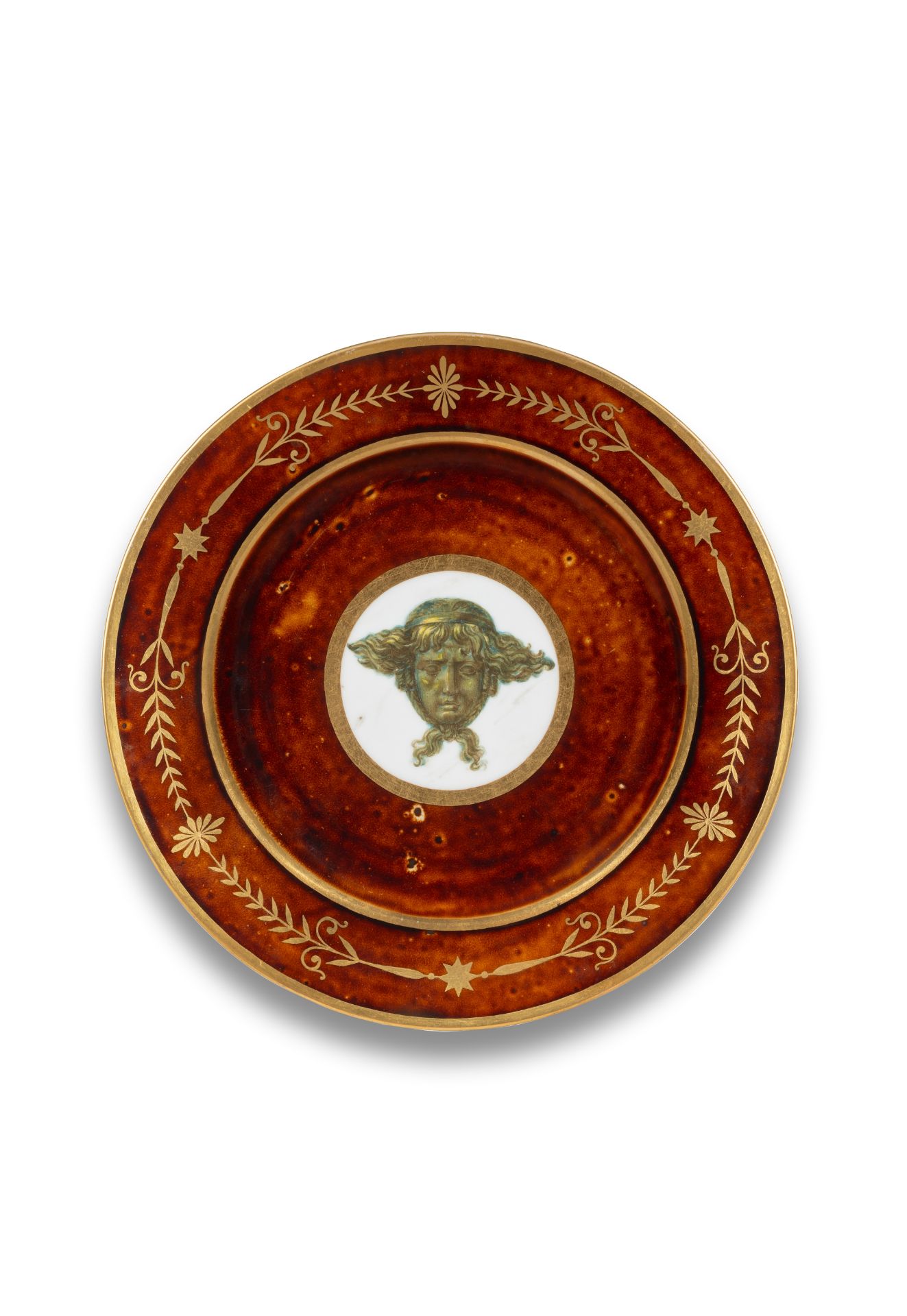 A S&#232;vres tortoiseshell-ground plate with mask of Apollo, circa 1803-05