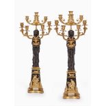 A pair of fine and impressive Empire 'Retour D'Egypt' gilt and patinated bronze seven light figur...