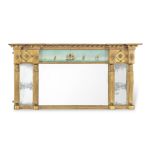 A late George III 'Egyptian revival' giltwood and reverse glass painted landscape overmantel mirror