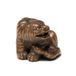 A wood netsuke of a tiger By Masanao, Yamada, Ise Province, Edo period (1615-1868), 19th century