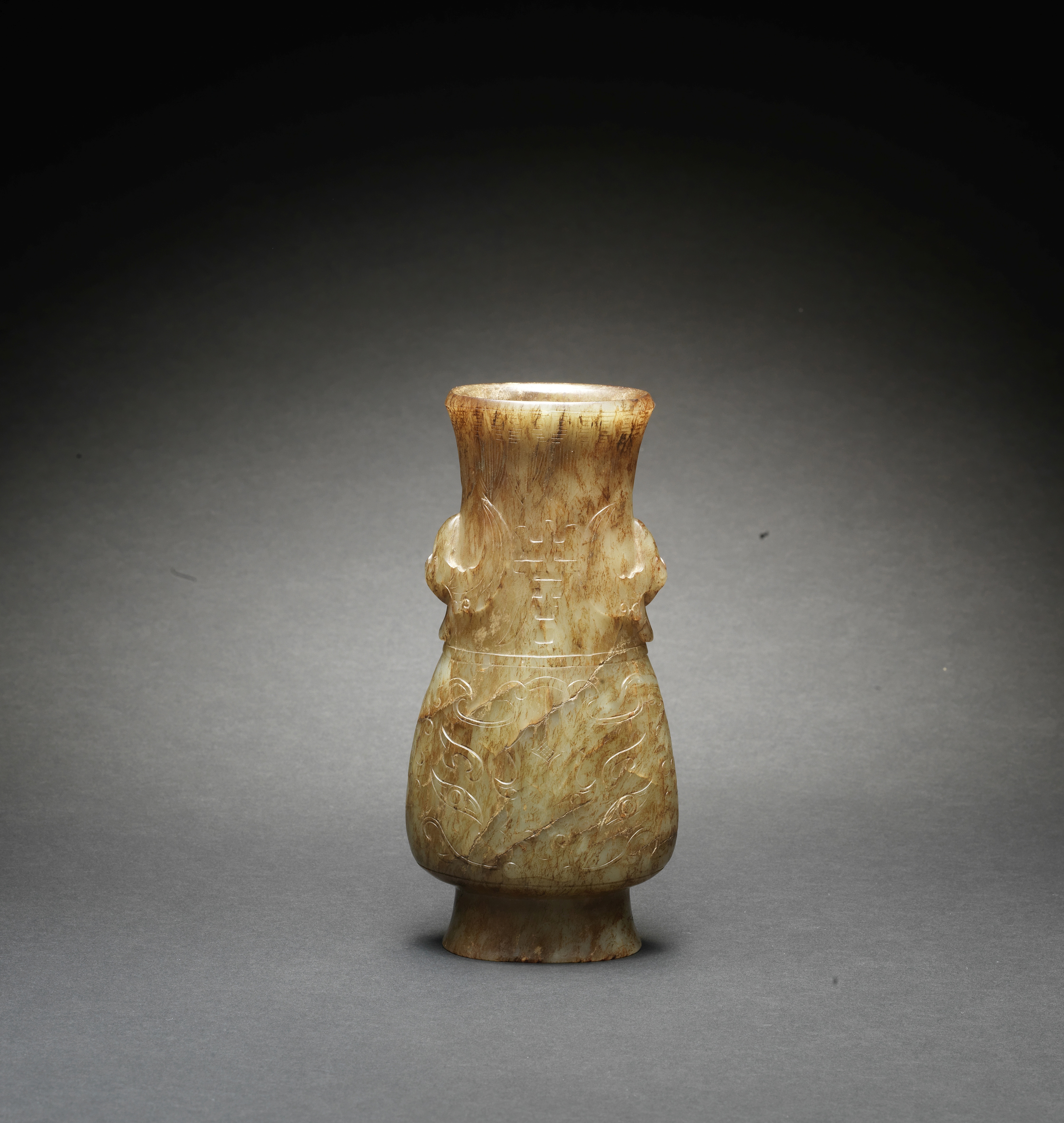 A PALE GREEN JADE ARCHAISTIC VASE, HU Ming Dynasty