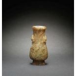A PALE GREEN JADE ARCHAISTIC VASE, HU Ming Dynasty
