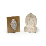 A marble carving of two disciples together with a limestone fragment of Buddha's head The discipl...