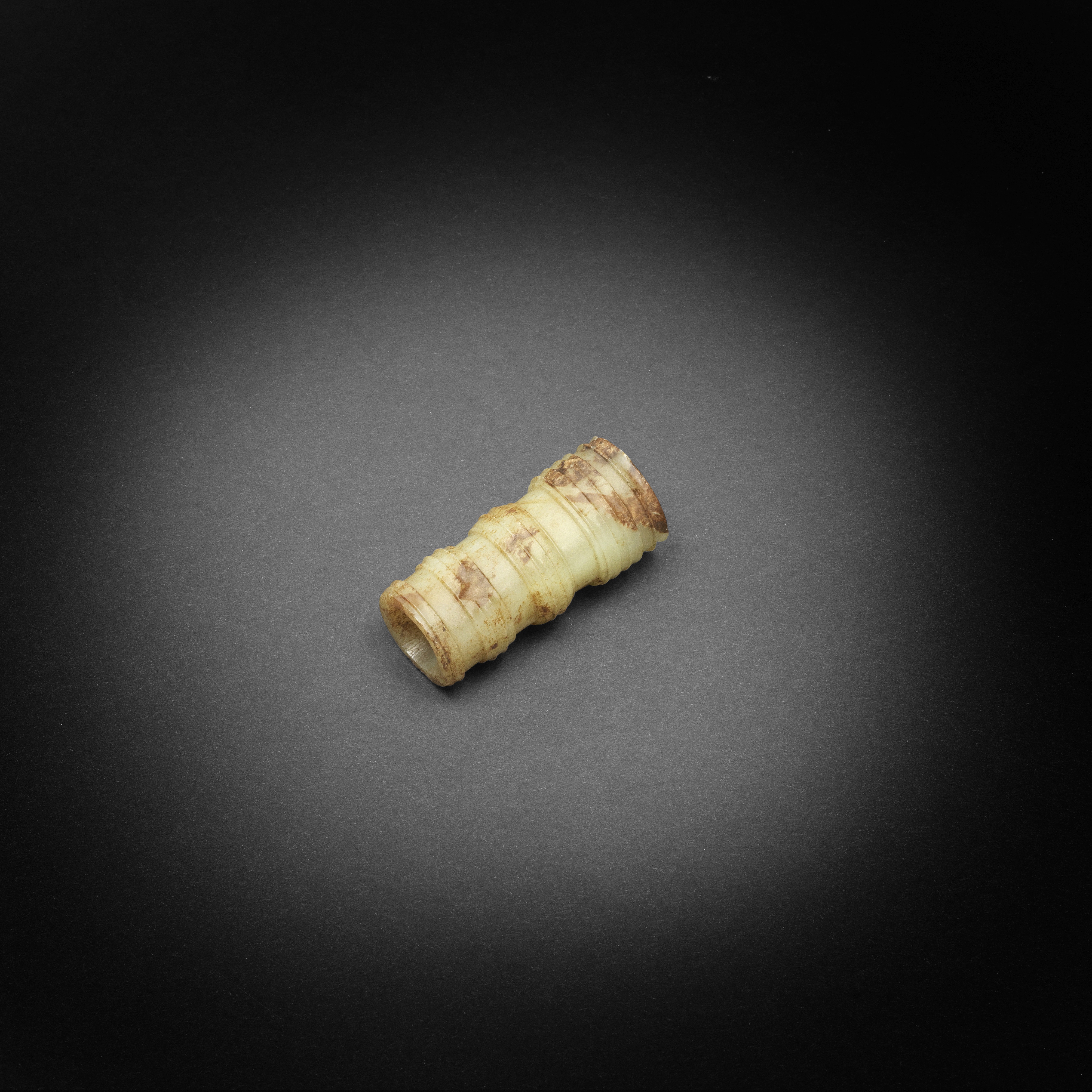 A yellow and russet jade tubular bead Eastern Zhou Dynasty