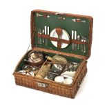 A wicker-cased 'Coracle' picnic set for four persons, by G.W.Scott & Sons, circa 1905,