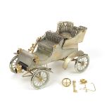 A 1:8 scale silver and gold model of a 1903 Model A Ford, by American Silversmiths Guild and Cart...