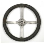 A vintage four-spoke steering wheel, patented 1906 and 1912,