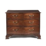 A George III mahogany serpentine commode of relatively compact proportions in the manner of Thoma...