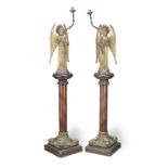 A pair of mid-19th Century polychrome and parcel gilt carved wood and brass Angel altar candlesti...