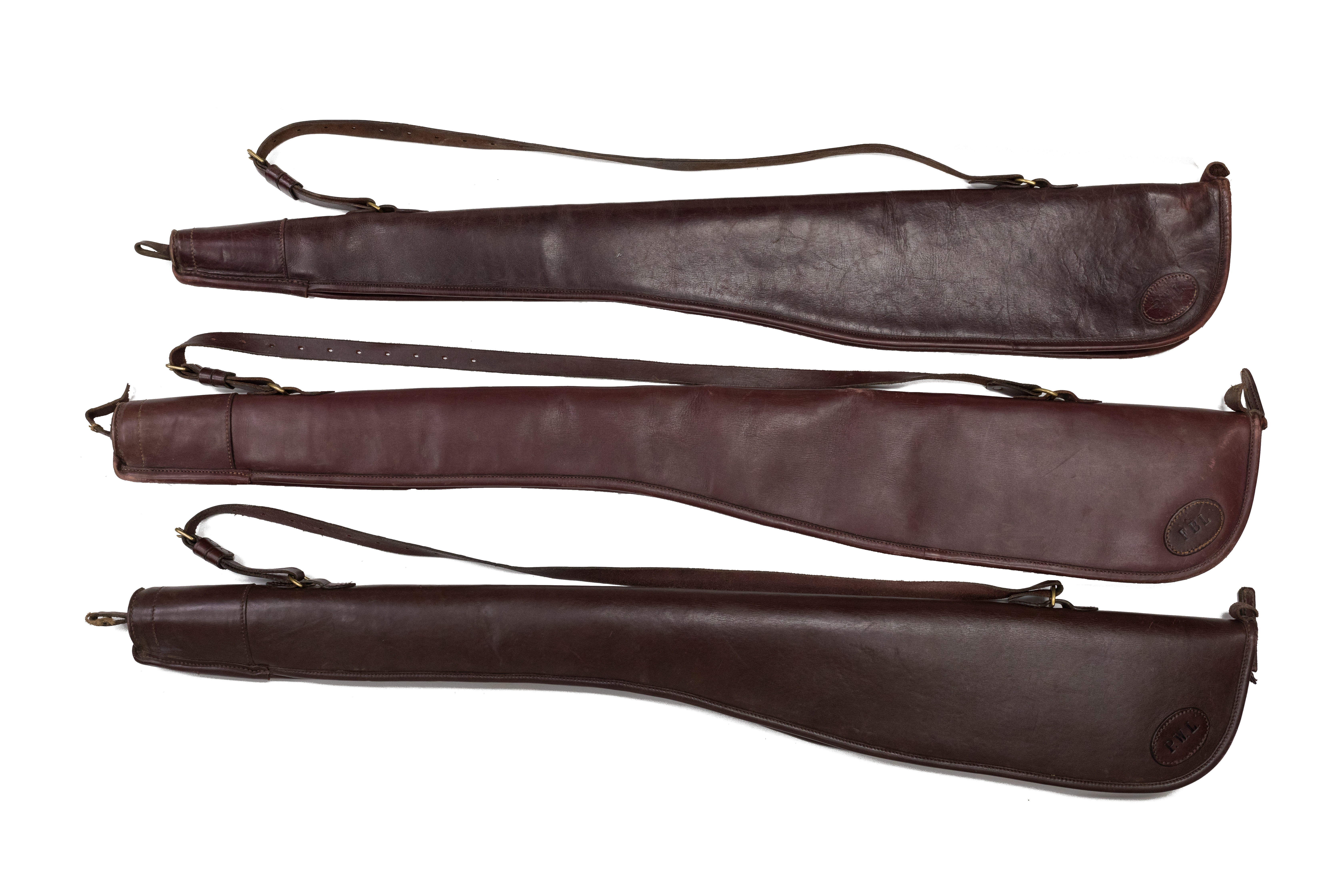 Three leather gunslips