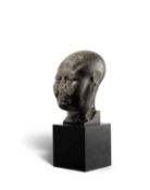 An Egyptian basalt head of a priest