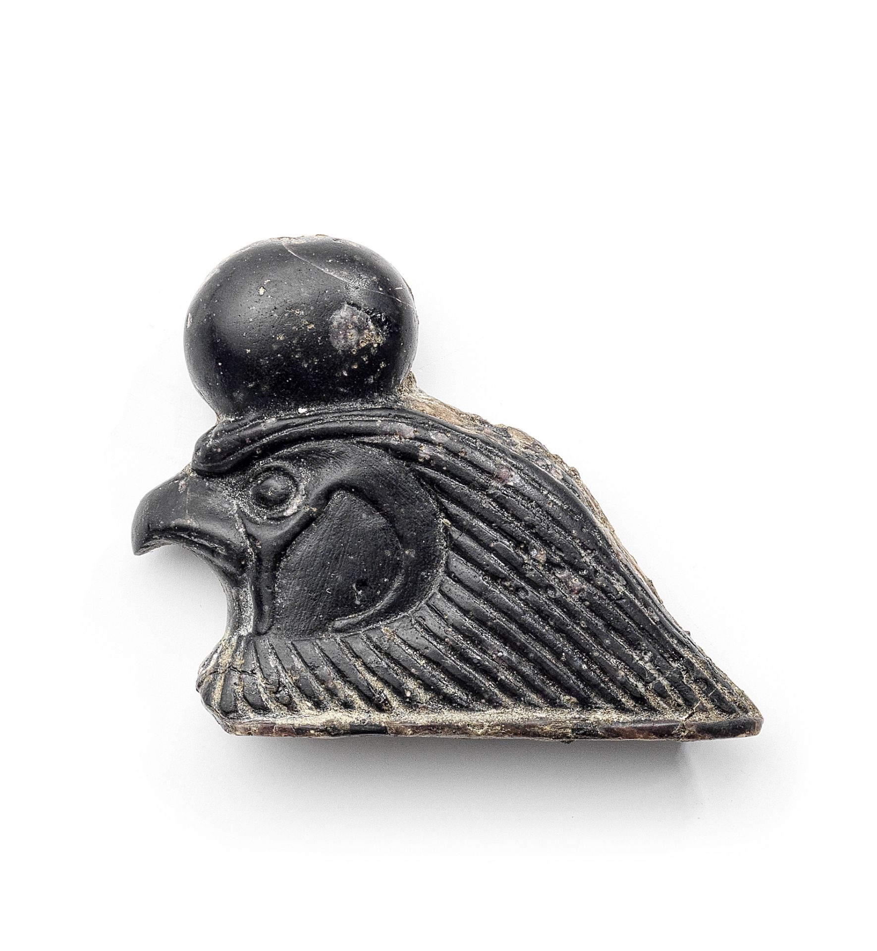 An Egyptian glass falcon head inlay