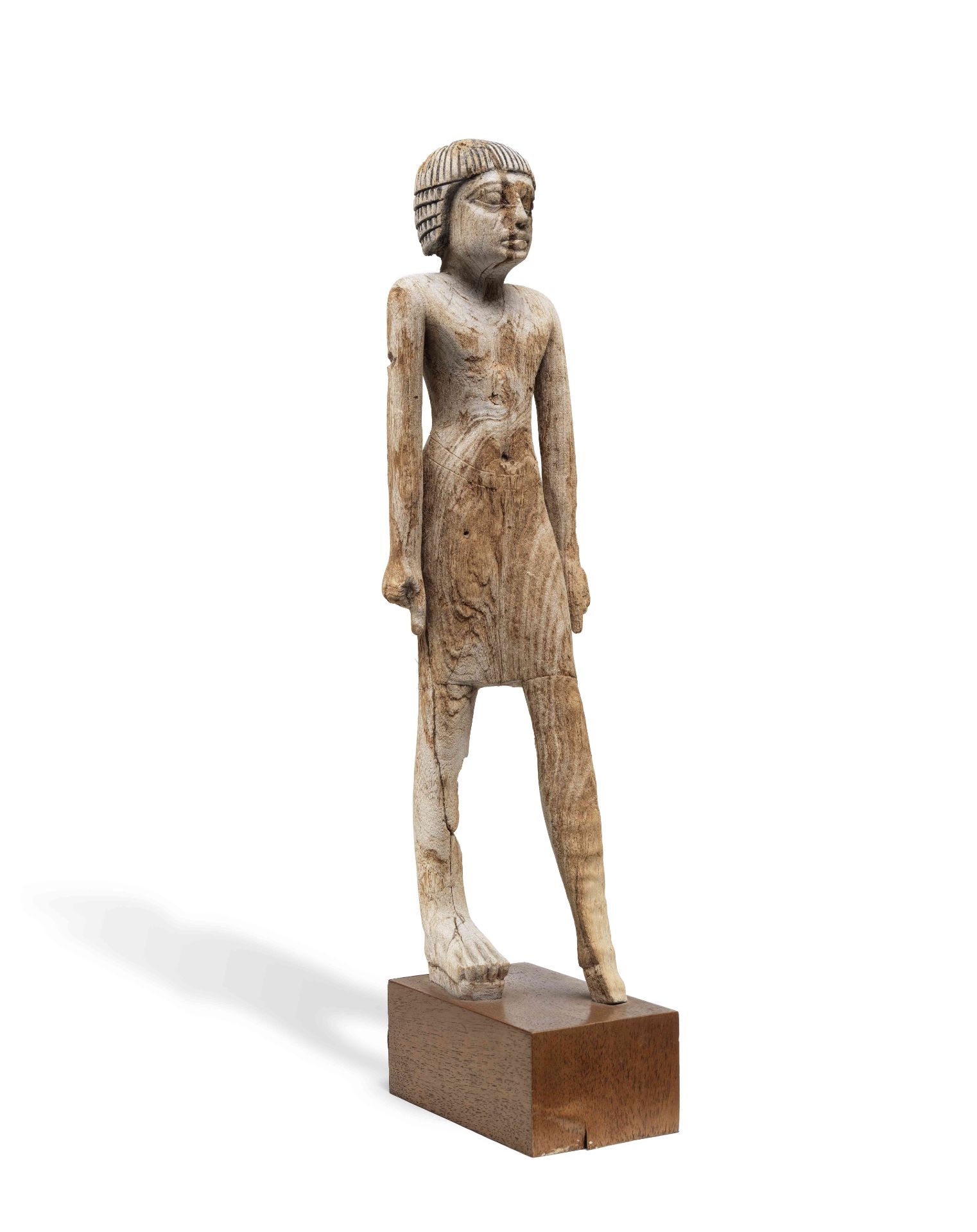 An Egyptian wood figure of a man