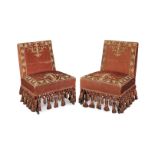 A pair of red velvet and metal thread embroidered slipper chairs 19th century, the upholstery pos...