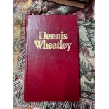 A Hard back book titled 'Dennis Wheatley' listing various titles 'The Devil Rides Out, The