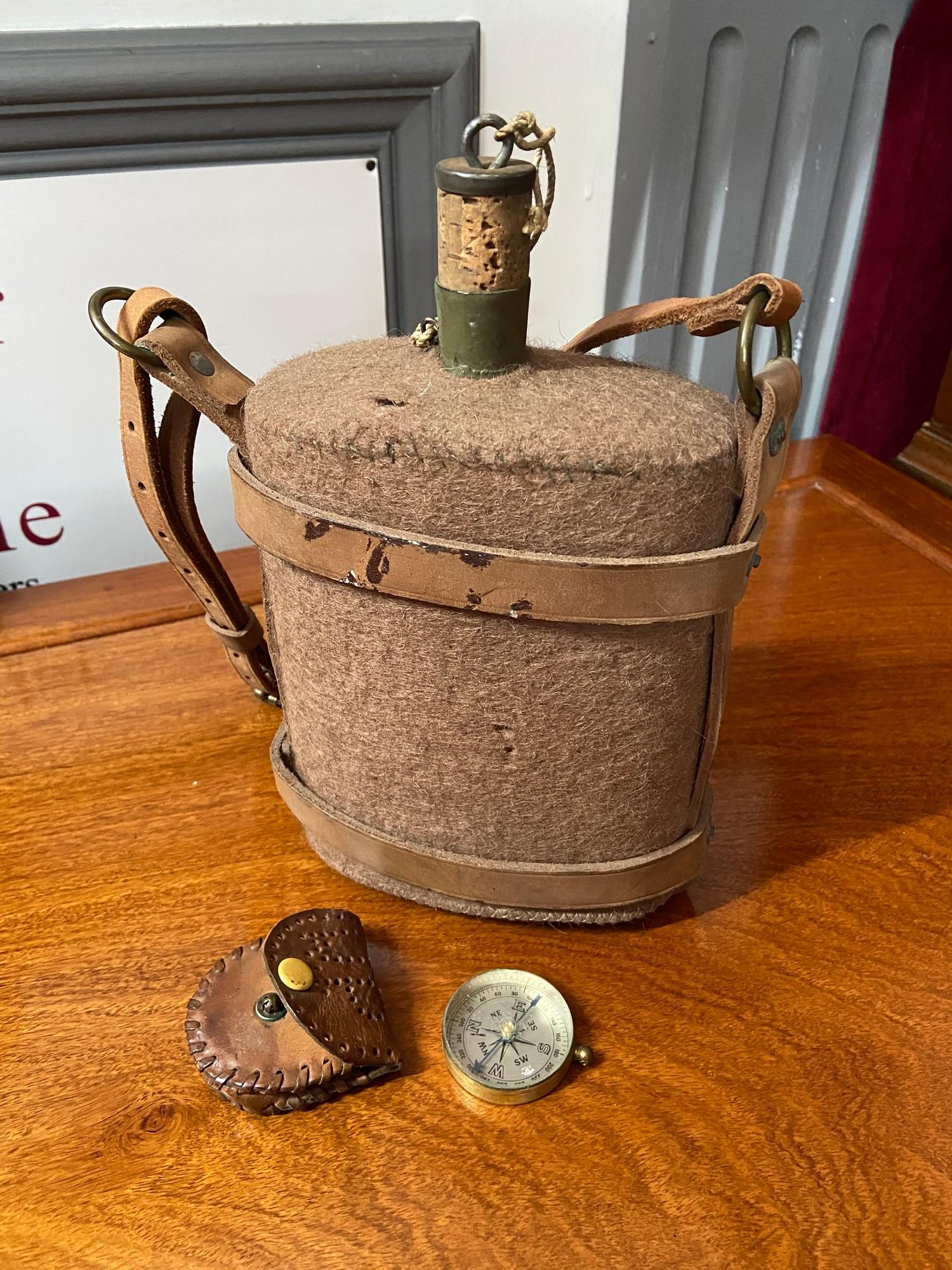 A Military style water flask with leather straps and original cork together with a vintage compass