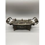 A 19th century bronze triple ink well desk stand. Detailed with interlinked snake handles, Claw feet