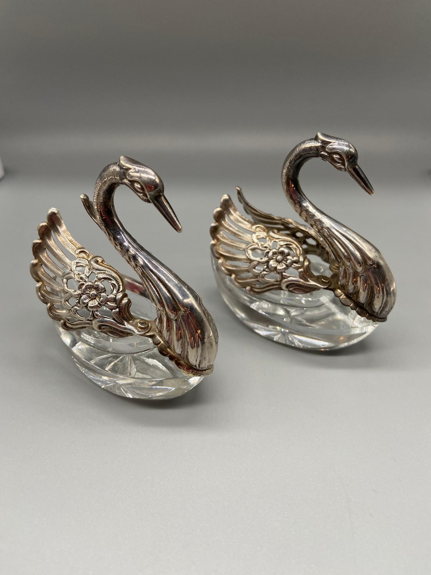 A Pair of Import London silver swan salt dishes. Designed with articulated wings and crystal cut