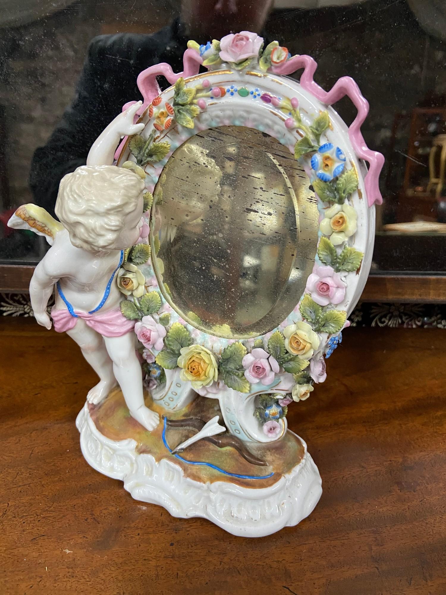 A 19th century Sitzendorf Cherub and floral design mirror. [
