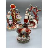 A Lot of three 19th century Staffordshire figures. One of a lady milking a cow spill vase.