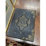 A Large 19th century family bible designed with brass bounds.