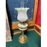 A Victorian Glass and brass paraffin desk lamp. Designed with a brass column base, green glass