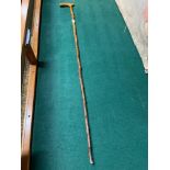 Antique walking cane detailed with a metal moulded snake. [