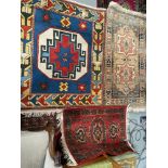 Four various ornate rugs