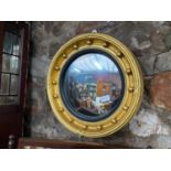 A Regency style convex mirror designed with various moulded trims and spheres. [