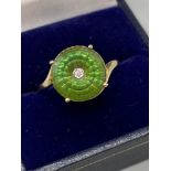 An exquisite designed ladies 9ct/10K gold ring. Designed with a large green round cut stone with a