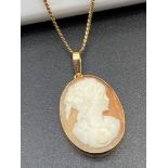 An 18ct gold [750 marked] necklace with an 18ct gold framed carved cameo pendant. [6 Grams] [45cm in