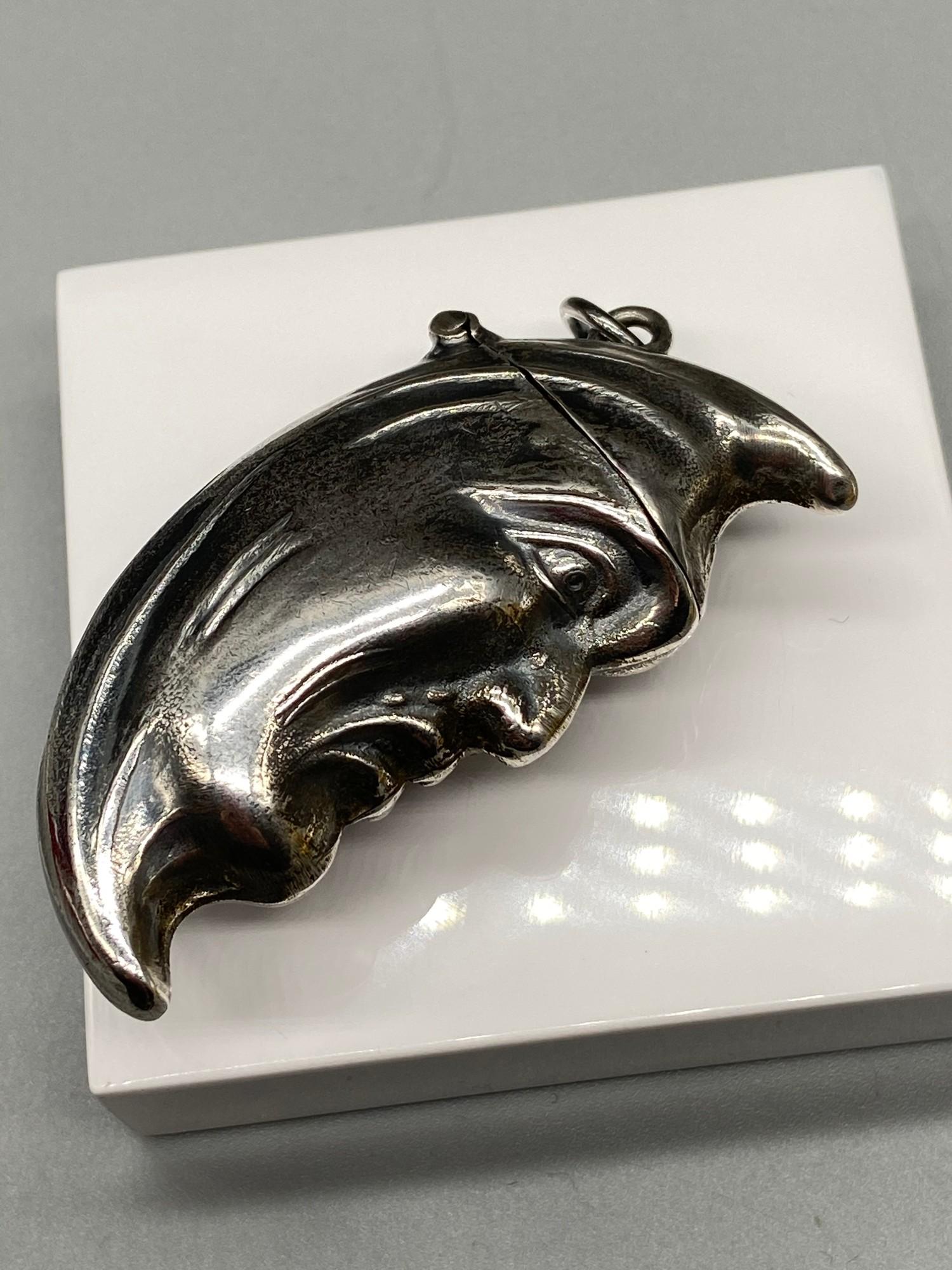 A Silver plated vesta case in the form of a half moon.