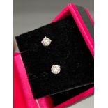 A Pair of 14ct white gold diamond stud earrings of 65 points.