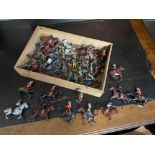 A Wooden tray containing a quantity of vintage Britain's lead cow boys and Indians