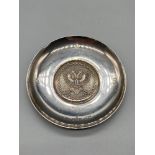 A Britannia Silver pin dish designed with a double head eagle to the centre. [9.3cm in diameter]
