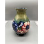 A Moorcroft vase designed with hibiscus flowers. Impressed marking W. Moorcroft Potter to H.M. THE