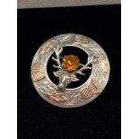 An Edinburgh silver stag brooch with yellow metal thistle head and leaf designs. Stag has a